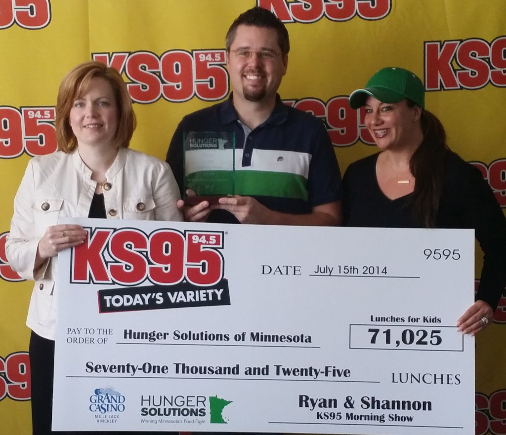 Ryan and Shannon of KS95 present Jessica with a big check.